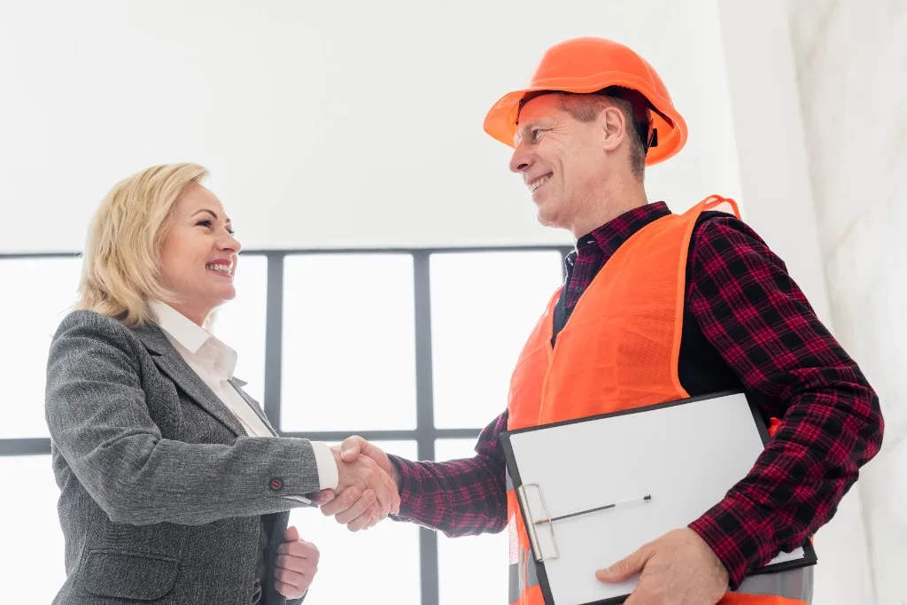 A Structexa engineer and client shaking hands on a project