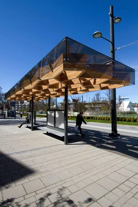 Timber and glass canopy on steel columns along a public walkway